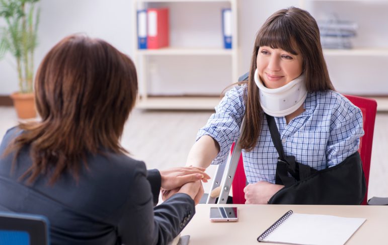 Injured employee visiting lawyer for advice on insurance